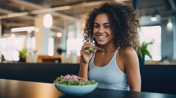 Woman Laughing Alone With Salad.