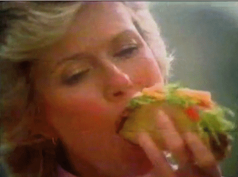 Woman-eating-a-taco-that-is-too-stuffed